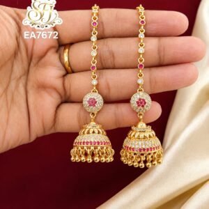 Premium gold finish long chain jhumka earrings with sparkling CZ white stones, ruby pink stones, and traditional dome design for bridal and festive wear.