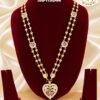 Premium gold finish heart pendant long haram with sparkling AD stones, ruby stone detailing, and heart link chain, perfect for bridal, wedding, and festive wear.