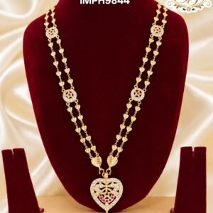 Premium gold finish heart pendant long haram with sparkling AD stones, ruby stone detailing, and heart link chain, perfect for bridal, wedding, and festive wear.