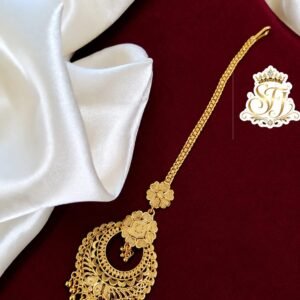 Traditional floral gold covering bridal maang tikka with intricate ethnic design.