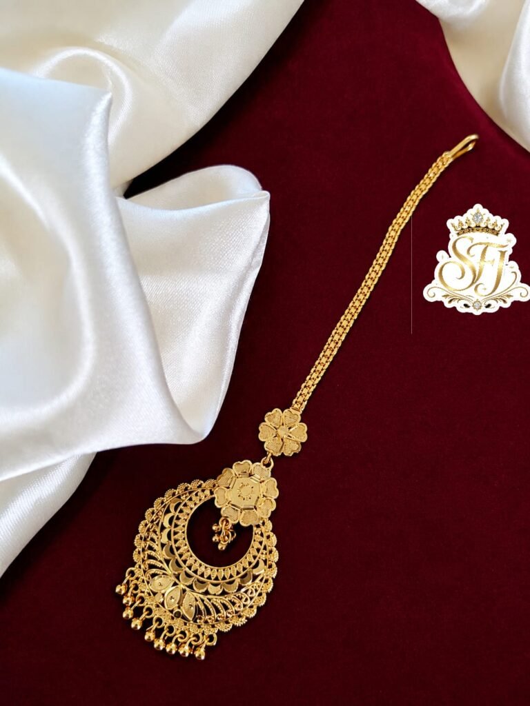 Traditional floral gold covering bridal maang tikka with intricate ethnic design.
