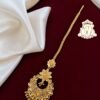Round antique gold covering maang tikka with floral detailing.