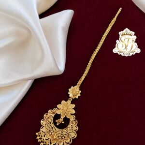 Round antique gold covering maang tikka with floral detailing.