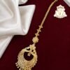 Premium traditional gold covering bridal maang tikka with intricate detailing.