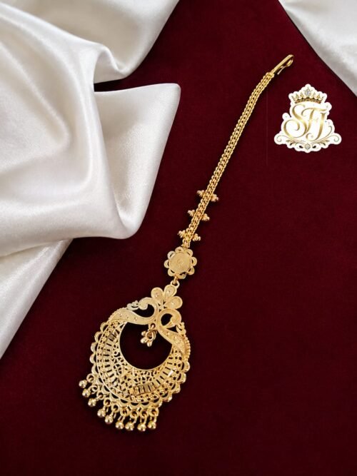 Premium traditional gold covering bridal maang tikka with intricate detailing.