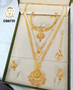 Premium Impon bridal combo jewellery set with long haram, choker, earrings, maang tikka and short pendant chain in gold polish with ruby stone accents.